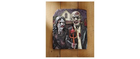 An image of a resin wall sculpture featuring a male zombie holding a pitchfork with a female at his style in the style of the "American Gothic" painting.