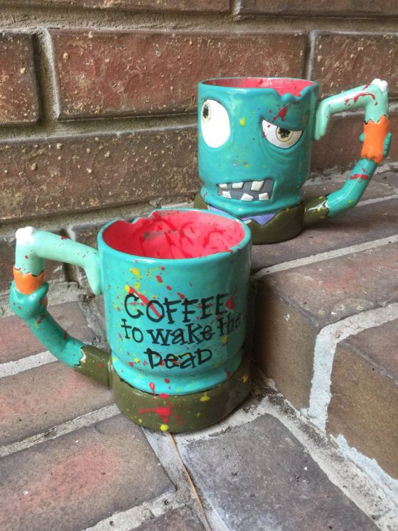 Front and back view of adorable hand made ceramic zombie coffee mug