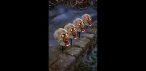 Zombie head pathway markers Set of 4 with glowing orange eyes in landscaping against a foggy background