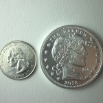 The 39mm diameter Barber Silver Zombucks Round compared to a US Quarter